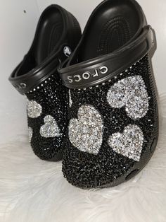 Women's size (black) clogs bling out with black diamonds with silver hearts You can request a different color clog by request. Can be substituted with gold hearts by request. Can be done with stars by request Bedazzled Crocs Winter's Lemonade Stand, Bedazzled Crocs Shoes Pink, Back To School Outfits Freshman, Decorated Crocs, Customize Crocs, Blinged Out Crocs, Croc Ideas, Crocs With Charms, Bedazzled Shoes Diy