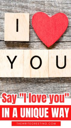 the words i love you are spelled by scrabble blocks with a red heart