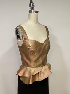 This blouse is a stunning piece made out of 100% Ombre silk in a wonderful rich pallet of beige tones and over the beige tones is sprinkled antique gold. It is lightweight and is fully lined. The blouse has princess seams and asymmetric peplum flared ham. Fastens in the back with small antique gold buttons.  The top gives a brilliance elegance and is prefect for evening, cockatiel and day time. Dimensions: Bust 36 inches Waist 29 inches Length from the shoulders to ham 22 inches Fits size medium Flared Blouse, Flare Blouse, Beige Tones, Evening Tops, Clothing Designs, Princess Seams, Princess Seam, Womens Blouses, Gold Buttons