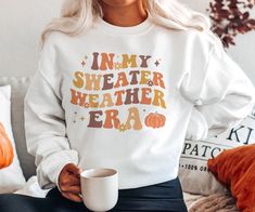 Step into the cozy embrace of autumn with our 'In My Sweater Weather Era' sweatshirt. Whether you're sipping on hot cocoa or enjoying walks through falling leaves, this sweatshirt lets you relish in the comfort and warmth of sweater weather. Get yours now! Available on tshirts and sweatshirts: https://www.etsy.com/shop/TheNims?search_query=Sweater+Weather+Era For other fall items, click here: https://www.etsy.com/shop/TheNims?search_query=Fall Browse through my other awesome items here: http://t Paraprofessional Outfits, Plus Size Herbst, Crewneck Aesthetic, Teacher Attire, Thanksgiving Sweater, Teacher Fits, Teaching Outfits, Dog Mom Sweatshirt, Bookclub Gifts