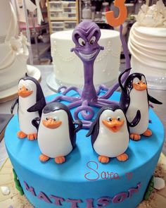 a birthday cake with penguins and an octopus on top