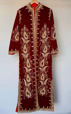 Your 1970s caftan dress represents a timeless piece of elegance, skillfully blending oriental tradition with vintage refinement. Its elaborate manual embroideries, crafted with golden thread, semi-precious pearls, and delicate sequins, showcase the exceptional craftsmanship of its time. Every detail reflects the artisanal mastery of that era, highlighting the passion and devotion of the creators behind this sartorial masterpiece. The dress's pristine condition, preserved like new, serves as evidence of meticulous care throughout the decades. More than just a garment, it becomes a chronicle of timeless elegance and the tradition of beauty. It carries not only the history of fashion but also the imprint of an era where textile art and intricate details reached their zenith. Dimensions: 40 in Intricate Embroidered Tunic Dress For Festivals, Traditional Tunic Abaya With Floral Embroidery, Elegant Kaftan With Multicolor Resham Embroidery, Traditional Tunic Maxi Dress For Festive Occasion, Bohemian Kaftan With Zari Work For Transition Season, Ceremonial Dresses With Gold Embroidery For Festivals, Fitted Embroidered Kaftan For Eid, Festive Elegant Multicolor Embroidered Kaftan, Elegant Festive Multicolor Embroidered Kaftan