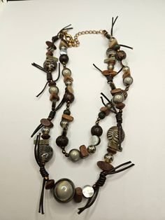 Vintage Chico's necklace in very good Vintage condition! Earthy Multi-strand Adjustable Necklace, Earthy Adjustable Multi-strand Necklace, Brown Beaded Multi-strand Jewelry, Vintage Brown Long Necklace As A Gift, Elegant Brown Multi-strand Beaded Necklaces, Handmade Brown Double Strand Jewelry, Vintage Brown Necklace For Gifts, Vintage Brown Necklace For Gift, Bohemian Brown Beaded Choker Necklace