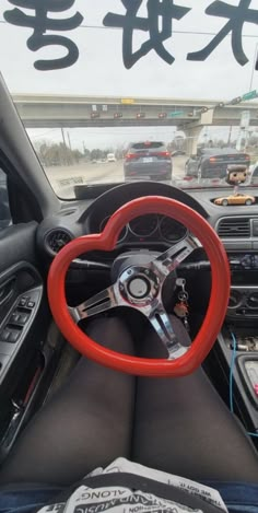 a steering wheel in a car with chinese writing on the window