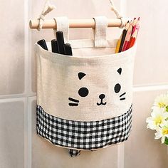 a cat shaped storage bag hanging on the wall