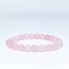 This beautiful Rose Quartz Bead Bracelet shows off the warm pinks and rose tones of Rose Quartz. This bracelet is associated with love and caring emotions and is said to bring love and friendship to those who wear and meditate upon it. The round beads are strung on the elastic thread to fit any wrist and are selected for their quality and richness of color. This bracelet is a perfect accessory for any outfit and easy to you wherever you go. Pink Adjustable Rosary Bracelet For Healing, Adjustable Pink Rosary Bracelet For Healing, Pink Beaded Stretch Bracelet For Healing, Pink Rose Quartz Round Beaded Bracelets, Pink Rose Quartz Bracelets For Meditation, Adjustable Pink Rosary Bracelet With 8mm Beads, Pink Rose Quartz Round Stretch Bracelet, Pink Spiritual Bracelets For Friendship, Pink Rose Quartz Bracelet For Meditation