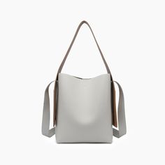 The Desert Dreamer Vegan Tote Bag has understated elegance and versatile design, making it a go-to accessory for the urban nomad. Add a touch of sophistication to any outfit and carry your dreams wherever you go. 100% Vegan Leather 12"W * 13"H * 7"D 6" top handle drop 22" detachable chain link Pull magnetic closure 16.50 oz Style# U2CN07 Minimalist Square Shoulder Bag For Shopping, Versatile Rectangular Bag With Leather Handles, Modern Bucket Box Bag For Errands, Gray Large Capacity Top Handle Shoulder Bag, Versatile Cream Square Shoulder Bag, Gray Rectangular Hobo Bag For Daily Use, Rectangular Gray Hobo Bag For Daily Use, Chic Square Bucket Bag For Everyday Use, Gray Tote Shoulder Bag With Adjustable Strap