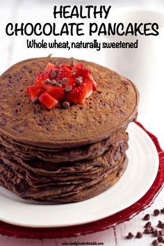 stack of chocolate pancakes with strawberries on top