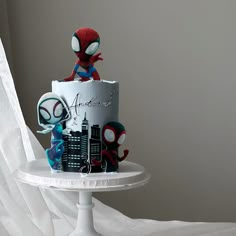 a spiderman themed cake on a white plate