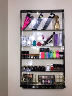 a shelf filled with lots of different types of hair products and cosmetics on top of it