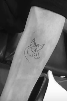 a person with a tattoo on their arm and the outline of a fox is shown