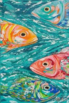 three colorful fish swimming in the ocean