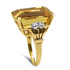 Capture the essence of the Retro Mid-Century era with this exquisite 14kt Yellow Gold Citrine and Diamond Cocktail Ring. At its center, you'll find a magnificent emerald step-cut citrine, an impressive 16.6 carats in weight, held securely in a four-prong basket setting. The citrine's dimensions of 19.68 x 13.18 x 9.68 mm are a testament to its grandeur.This striking citrine is beautifully complemented by four full-cut diamonds, adding a touch of elegance and sparkle to the design. The total diam Stone Ring Design, Basket Setting, Diamond Cocktail Ring, Step Cut, Diamond Cocktail Rings, Retro Mid Century, Fine Jewels, Online Jewelry Store, Cocktail Ring