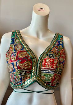 A green color embroidered blouse  Product details Fabric -Georgette Embroidery - Silk threads and sequins Bust size 34" Waist 28" Can be tailored to fit 36" For extra charges Sleeveless Embellished Choli For Festive Occasions, Bollywood Style Sleeveless Embellished Choli, Bollywood Sleeveless Embellished Choli, Traditional Embellished Sleeveless Choli, Festive Multicolor Embroidered Fitted Top, Festive Green Sequined Tops, Festive Green Sequin Tops, Embellished Multicolor Embroidered Choli, Bollywood Style Multicolor Embroidered Festive Top