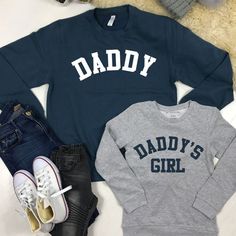 We can't even deal with the cuteness of these Daddy & Daddy's Girl father & daughter matching sweatshirts. ITEMS IN SET SOLD SEPARATELY - simply add sizes into cart separately using the drop down menu above.  Daddy & Daddy's Girl matching Classic styled sweatshirts Crew Neck College style text Ringspun cotton Wash at 30 Degrees Family Matching Graphic Print Sweatshirt, Father's Day Casual Sweatshirt With Name Print, Family Matching Crew Neck Sweatshirt For Father's Day, Father's Day Cotton Sweatshirt With Name Print, Family Matching Long Sleeve Letter Print Tops, Casual Winter Tops For Family Occasions, Family Matching Long Sleeve Sweatshirt With Name Print, Family Cotton Sweatshirt With Letter Print, Family Occasion Sweatshirt With Letter Print And Long Sleeves