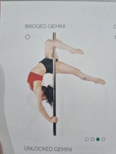 a woman is standing on a pole with her legs spread out and feet bent over the pole