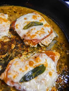 some food is cooking in a skillet on the stove and ready to be eaten