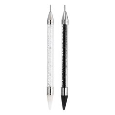 a black and white pen with glitter on the tip is sitting next to another pen