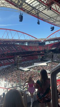 a woman standing in front of a crowd at a stadium