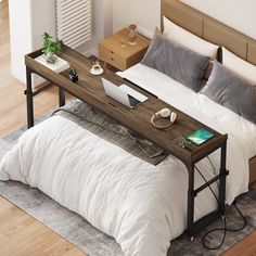 a bed with a laptop on top of it