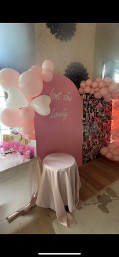 some balloons are hanging from the ceiling near a table