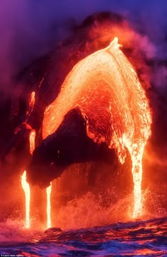 the lava flows into the ocean as it erupts water from its mouth