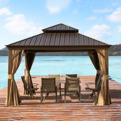 a gazebo with chairs and tables on a wooden dock