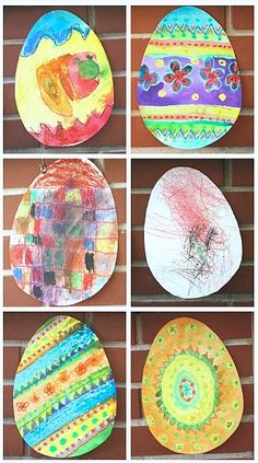 four pictures of different colored paper plates hanging on a brick wall