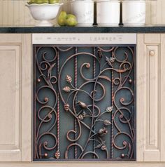 a kitchen with white cabinets and an ornate iron grill in the center, surrounded by fruit