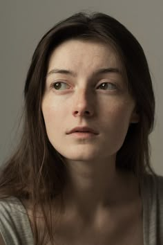 a woman with freckled hair is looking at the camera