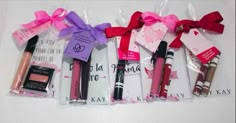 various items are wrapped in cellophane and tied with pink ribbon on white surface