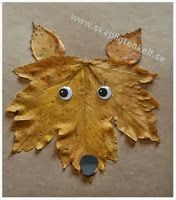 a close up of a leaf with eyes and leaves in the shape of a dog's head