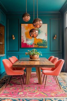 a dining room with blue walls, pink chairs and a wooden table in the center