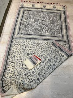 A beautiful Worli work kantha saree . The whole body of the saree finished with intricate hand stitch kantha works . To give a unique look to that black and white red piping added .  Saree comes with a running blouse piece with kantha work on sleeves . Fall pico and tassels done . You can wear it with a red blouse also.  Blouse stitching option is here . Diwali Unstitched Mulmul Suit With Printed Border, Bohemian White Saree With Motifs, Bohemian Tussar Silk Blouse With Traditional Patterns, Unstitched Mulmul Traditional Wear With Printed Border, Festive Unstitched Saree Suit With Kalamkari Print, Unstitched Bohemian Blouse Piece With Printed Border, Bohemian Tussar Silk Saree With Traditional Patterns, Bohemian Traditional Wear In Cotton Silk With Printed Border, Bohemian Traditional Wear With Printed Border In Cotton Silk