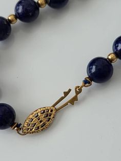 "Cheer up with this genuine blue lapis with gold tone spacer beads. Lapis stones have gold lines and are approx. 8mm. round Clasp: filigree fishhook Length approx. 25\" Condition: Good vintage" Handmade Royal Blue Round Beads Jewelry, Elegant Gold Beaded Necklaces With Lapis Lazuli, Traditional Round Lapis Lazuli Jewelry, Elegant Beaded Necklaces With Round Lapis Lazuli Beads, Elegant Lapis Lazuli Beaded Necklaces With Round Beads, Elegant Lapis Lazuli Beaded Necklace With Round Beads, Elegant Lapis Lazuli Beaded Necklaces, Elegant Lapis Lazuli Beaded Necklace, Lapis Lazuli Round Beaded Necklaces