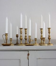 there are many candles that are lined up on the table