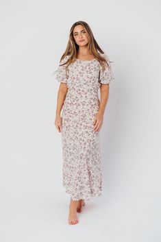 Discover effortless elegance in our charming Lucia Maxi Dress - it's already a favorite here at Worth Collective! This beautiful dress is cut on the bias, ensuring an ultra-flattering and feminine fit. The Lucia's puffed sleeves and flowy skirt only add to its vintage allure, and its gorgeous lilac floral print is spring-ready! Pair with pumps or dainty sandals for an extra-special event. FIT: Runs true to size. Fabric does not stretch; bias cut makes this dress more fitted through the waist and Modest Spring Dresses With Fitted Bodice, Feminine Fitted Maxi Dress For Brunch, Casual Maxi Dress With Fitted Bodice And Short Sleeves, Fitted Floral Print Maxi Dress With Puff Sleeves, Modest Floral Print Dress With Puff Sleeves, Feminine Fitted Maxi Dress With Short Sleeves, Modest Fitted Maxi Dress With Smocked Back, Modest Fitted Maxi Dress For Garden Party, Fitted Modest Maxi Dress For Brunch