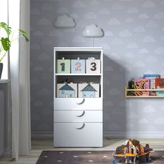 a child's room with a bookcase and toys on the floor in front of it