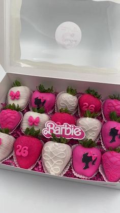 a box filled with pink and white chocolate covered strawberries