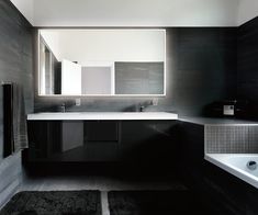 a bathroom with a sink, mirror and bathtub in it's center area