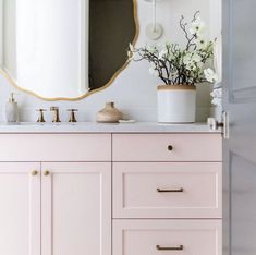 a bathroom vanity with two sinks and a large mirror