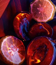 some oranges are cut in half on a table