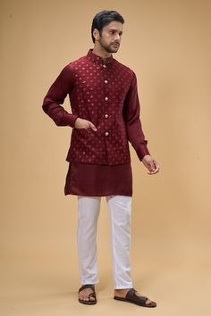 Maroon sleeveless bundi crafted in dupion silk featuring sequin-thread bloom quad embroidery. Paired with a solid maroon kurta and white pant., Fit: Relaxed Fitted Nehru Jacket In Cotton Silk With Straight Cut, Fitted Cotton Silk Nehru Jacket, Fitted Nehru Jacket In Cotton Silk, Designer Chanderi Nehru Jacket Fitted, Fitted Chanderi Nehru Jacket For Designer Wear, Fitted Sleeveless Chanderi Kurta, Fitted Chanderi Nehru Jacket Straight Kurta, Festive Cotton Nehru Jacket With Gota Work, Fitted Cotton Silk Bandhgala For Festivals