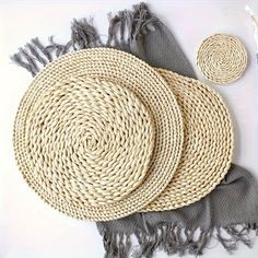 woven placemats and napkins laid out on top of each other next to a brush