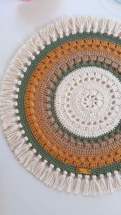 a crocheted doily is shown on a table