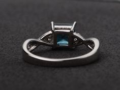 Welcome to my shop, you can find many beautiful gemstone jewelry here, and you also can ask for customized service. Main Stone: London blue topaz, princess cut, measures 6X6mm. Accent Stones: cz Metal: 925 sterling silver plated with rhodium. I also can provide metal options such as 14k solid yellow/white/rose gold Setting: prong setting more rings: https://www.etsy.com/shop/XCjewelryStudio?ref=hdr_shop_menu It's a perfect gift for the person who was born in November (Birthstone), it's quite com Fine Jewelry Princess Cut Topaz Promise Ring, Topaz Princess Cut Ring With Prong Setting As Gift, Gift Princess Cut Topaz Ring With Prong Setting, Elegant Silver Topaz Ring With Princess Cut, Elegant Silver Princess Cut Topaz Ring, Princess Cut Topaz Birthstone Ring For Promise, Elegant Square Cut Topaz Promise Ring, Elegant White Gold Princess Cut Topaz Ring, Princess Cut Topaz Ring With Accent Stones