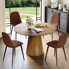 a dining table with four chairs around it