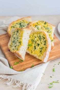 slices of bread with cheese and herbs on a cutting board