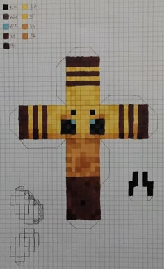 an image of a cross made out of legos and paper machches on a piece of graph paper