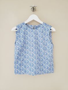 "Liberty sleeveless top / Cropped hem cotton blouse. Handmade by littleflowerfabric / Liberty Tana Lawn Top / Silk -like touch / Pullover STYLE * Fits neatly across the shoulders. * Gentle, shape that floats subtly away from the body. * No zipper, pullover. * Right above bust including armhole up to neckline is lined with the same fabric as blouse for fit. DETAILS * Made with Liberty Tana Lawn. Cotton 100%. Lightweight. Very soft. From the world famous Liberty Fabrics with a silk-like touch, unique print quality and striking color vibrancy. PLEASE NOTE * Made to order. Hand made. Neither returnable nor exchangeable. * All garments are approximate as to be expected with the handmade. PLEASE CHECK * The measurements carefully. (Especially the body BUST measurements) The most important thing Spring Sleeveless Cotton Blouse, Cotton Ruffle Tank Top, Cotton Floral Print Blouse For Daywear, Printed Cotton Sleeveless Tank Top, Fitted Cotton Tank Blouse, Cotton Floral Print Tops For Daywear, Fitted Cotton Sleeveless Blouse, Sleeveless Cotton Tops For Daywear, Cotton Sleeveless Tops For Daywear